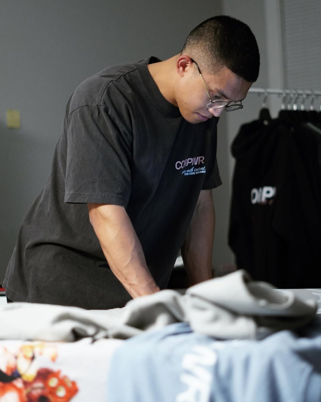 COR athlete focused at a workstation in a branded shirt